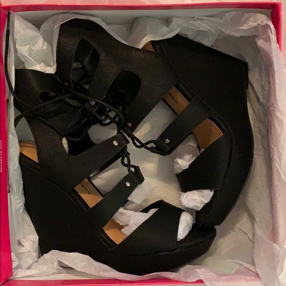 Black wedge lace up heels.
